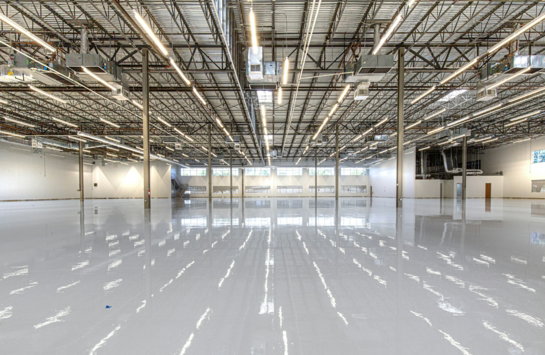 Shiny warehouse floor with overhead lights and ceiling