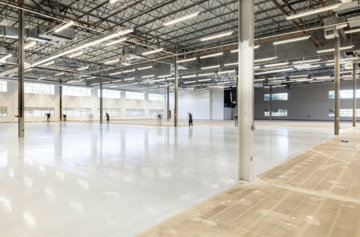 Empty, modern warehouse interior with polished concrete floor.